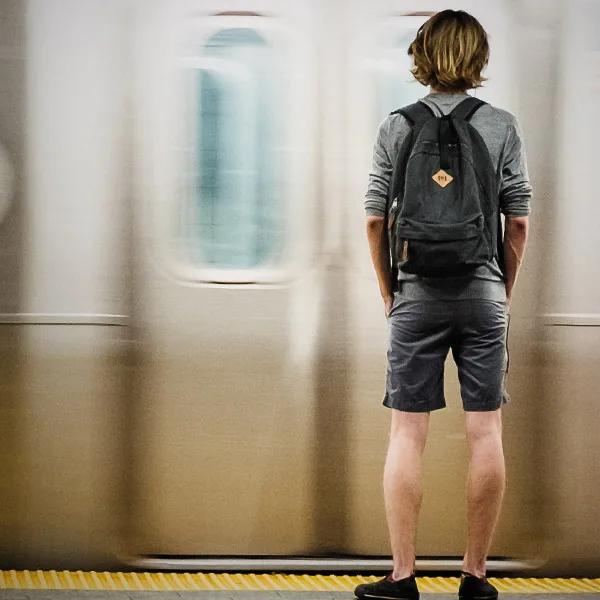 A man boarding a silver line train